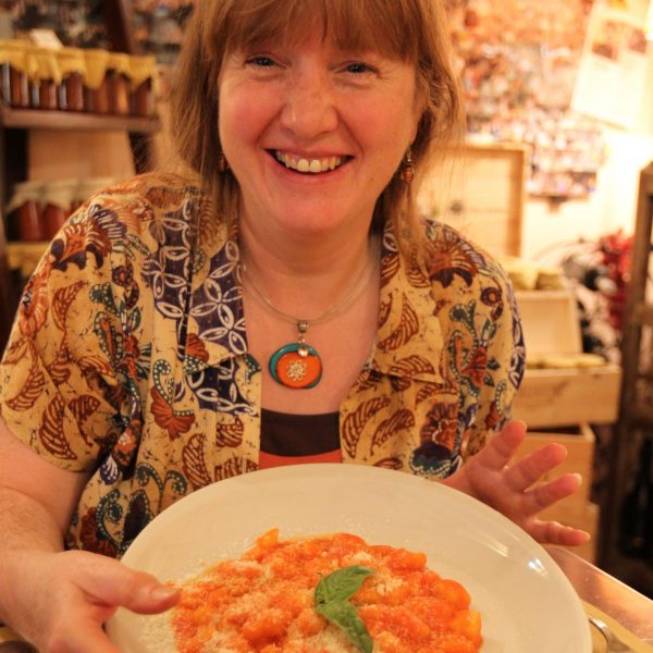 student with a plate of pasta